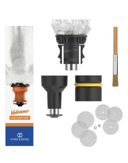 Volcano balloon kit components laid out: orange valve, black adapters, clear plastic bag, yellow-ring seal, brush, and several silver filter discs with washers nearby.